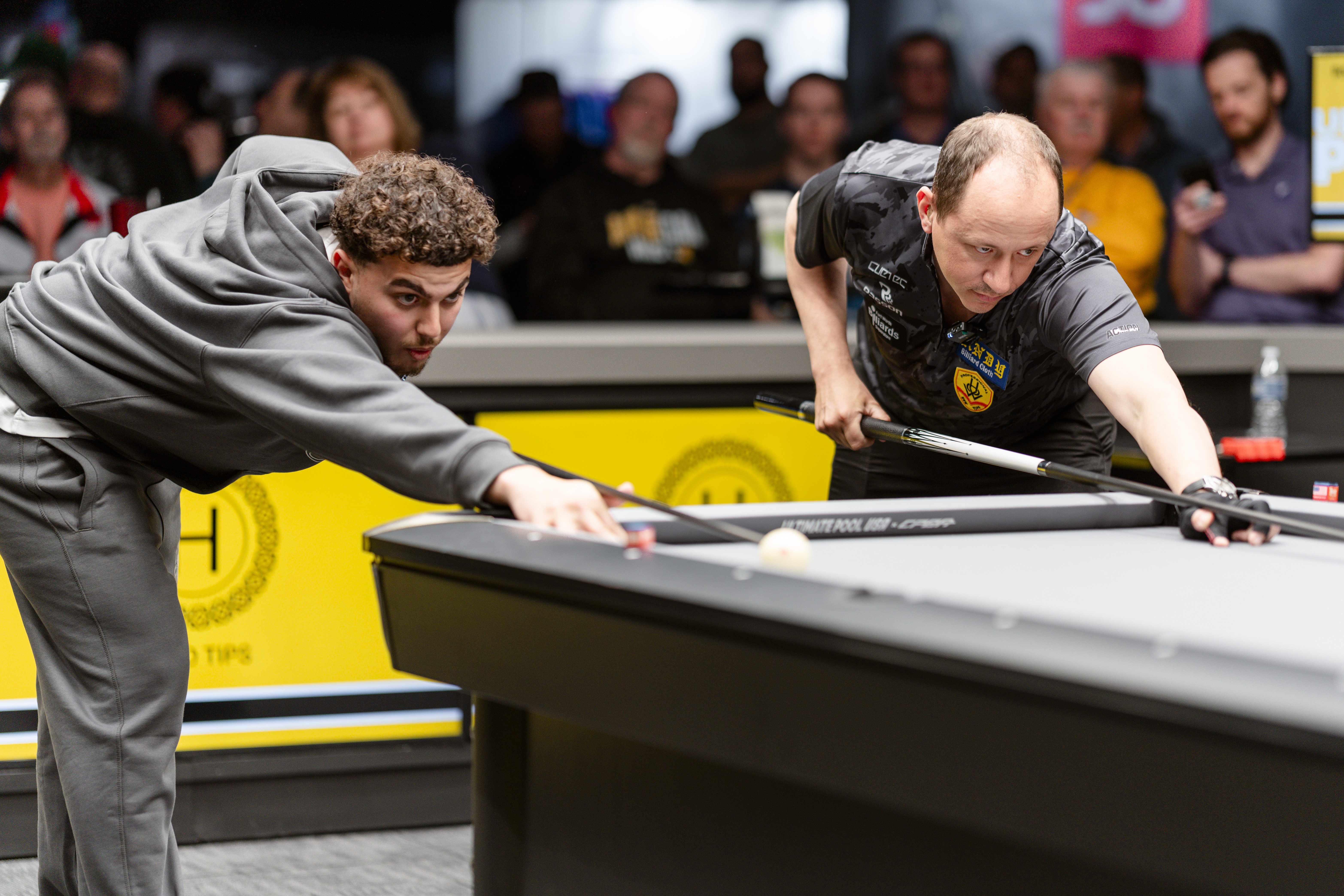 Ayd and opponent both taking shots side by side