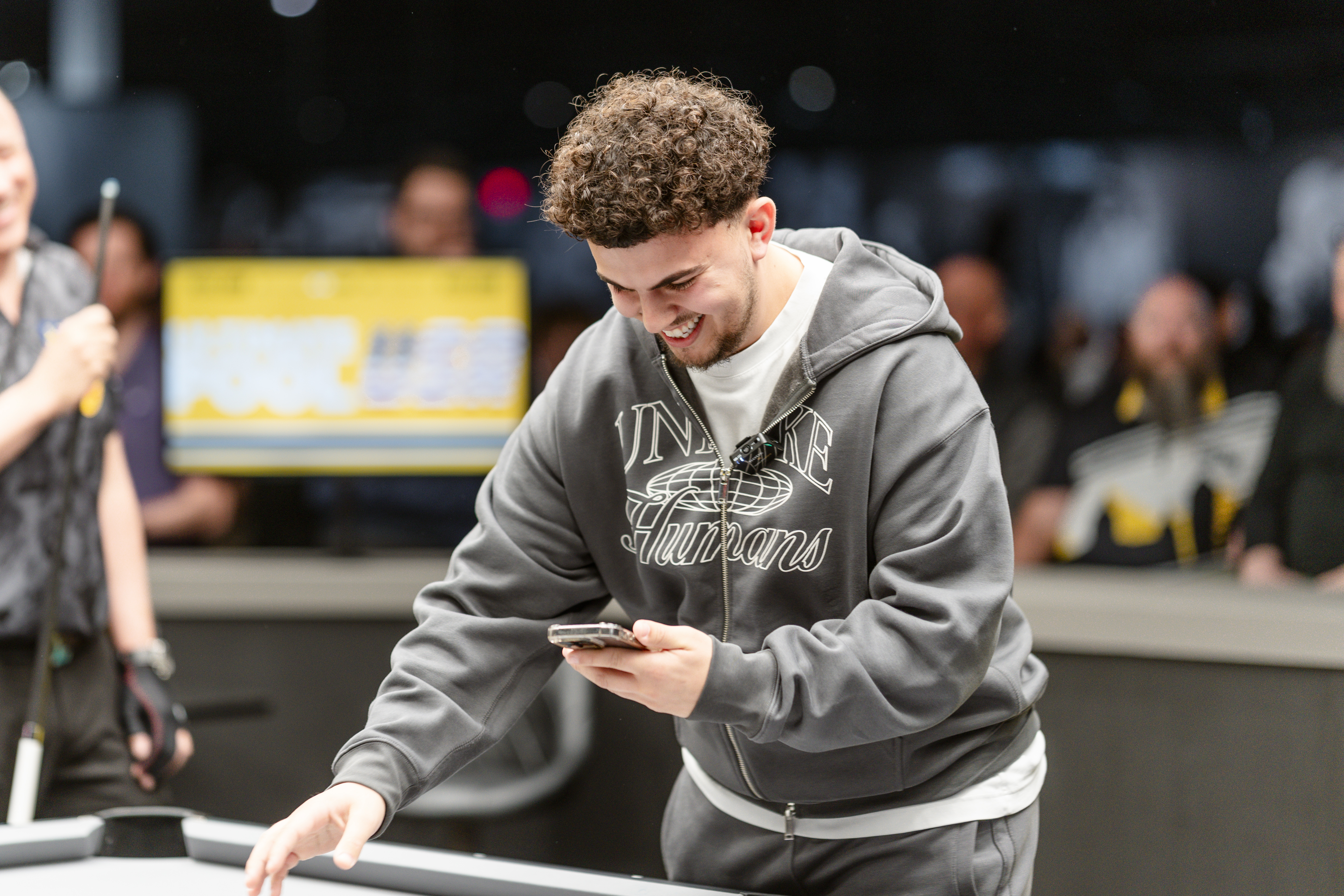 Ayd checking his phone and laughing